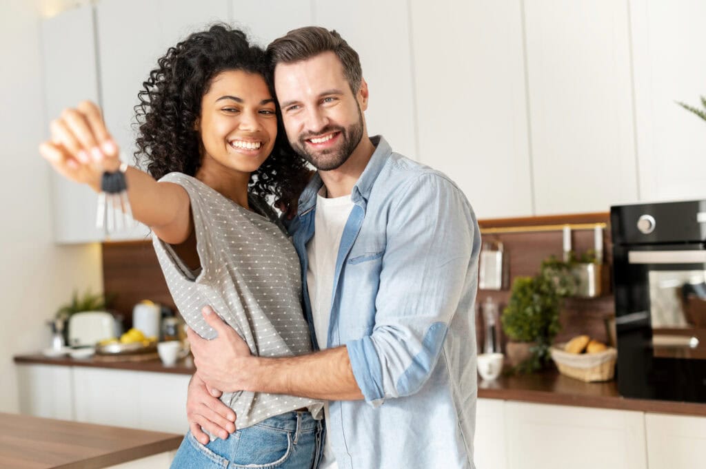 interracial couple holding a key ring in hand