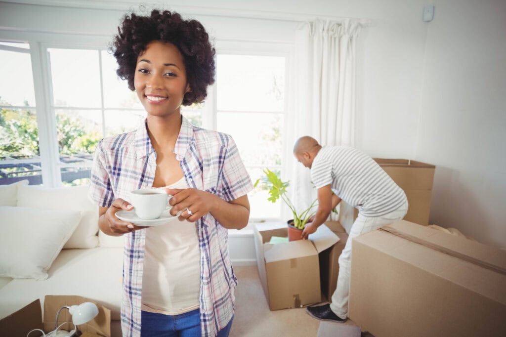happy woman holding cup in the living room